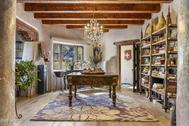 office area with beam ceiling and a notable chandelier