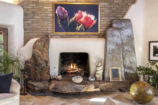 room details featuring a warm lit fireplace