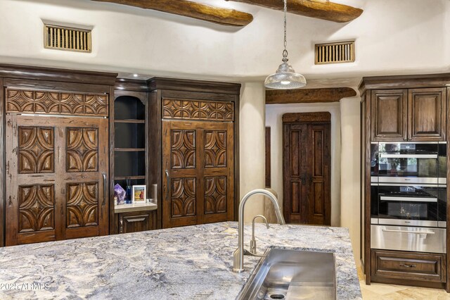 kitchen featuring stainless steel double oven, visible vents, a sink, and a warming drawer