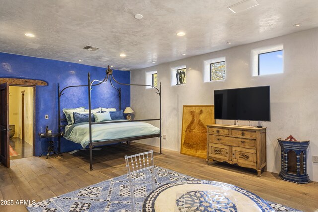 bedroom featuring recessed lighting, visible vents, and light wood-style floors