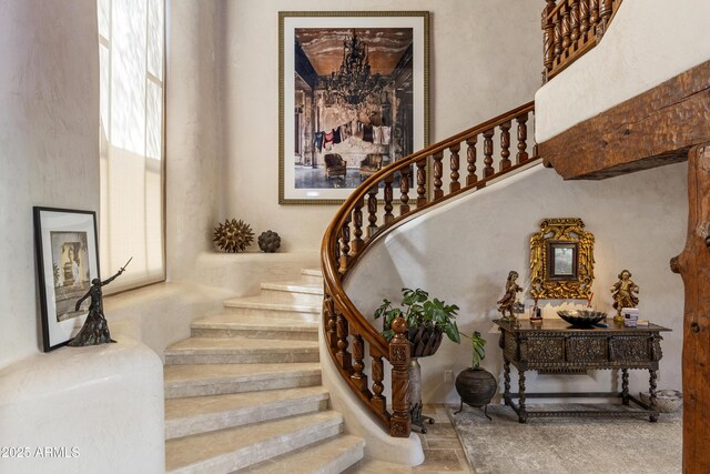 stairs featuring a high ceiling