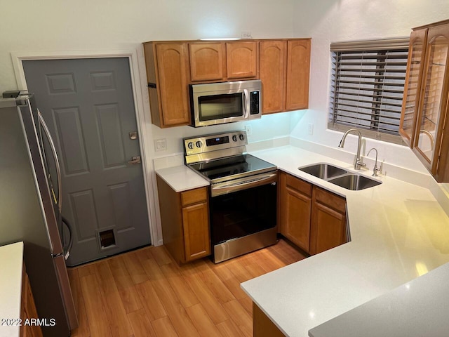 9070 E Gary Rd Unit 152, Scottsdale, AZ 85260 - kitchen with appliances with stainless steel finishes, light wood finished floors, and brown cabinetry