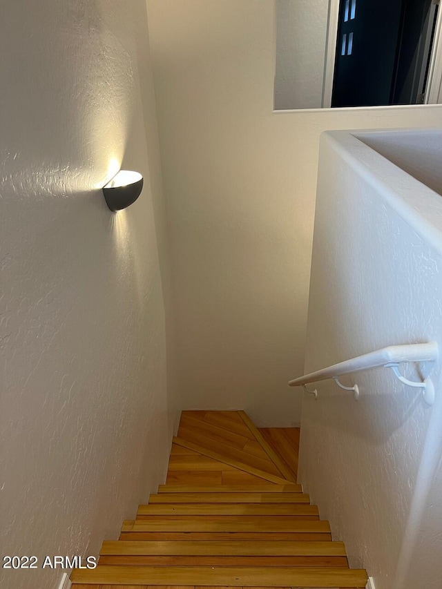 9070 E Gary Rd Unit 152, Scottsdale, AZ 85260 - staircase with a textured wall and wood finished floors
