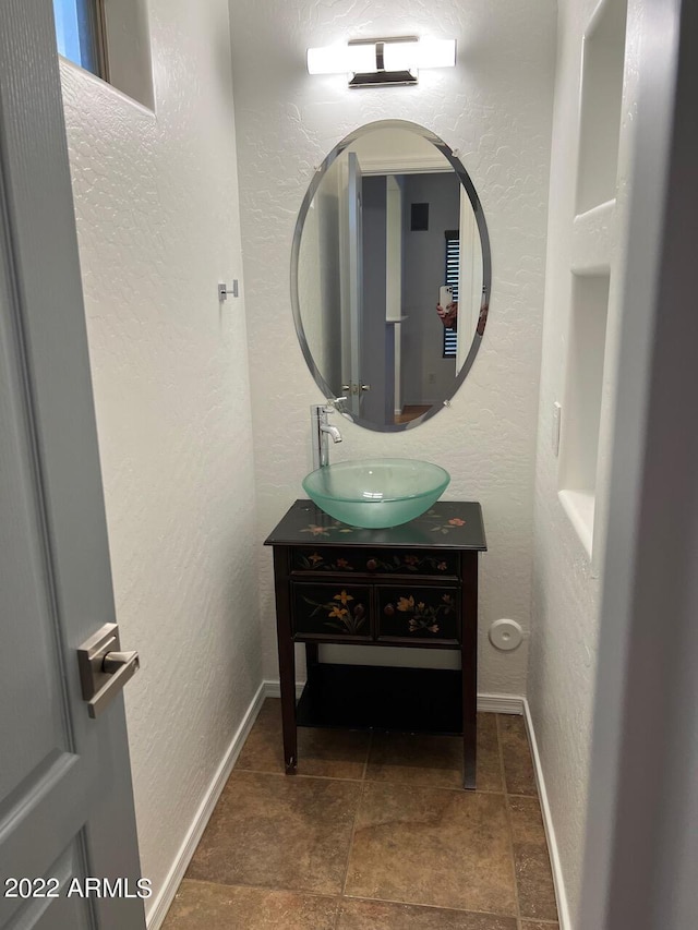9070 E Gary Rd Unit 152, Scottsdale, AZ 85260 - bathroom with vanity, a textured wall, and stone finish flooring