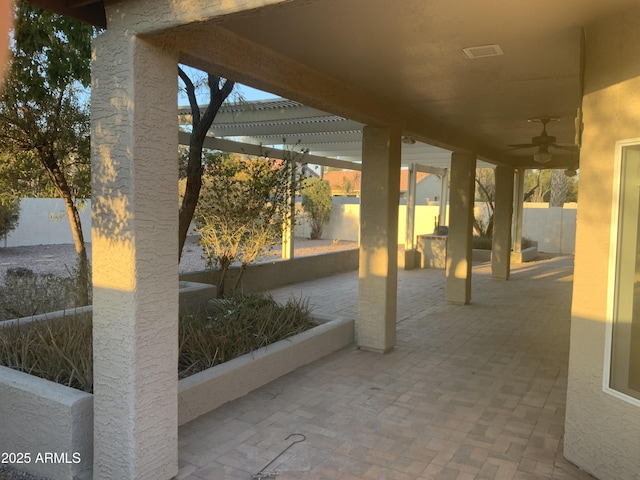 view of patio with ceiling fan and a pergola