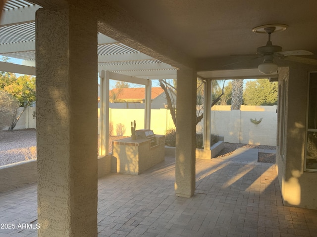 view of patio / terrace with ceiling fan, an outdoor kitchen, and a pergola