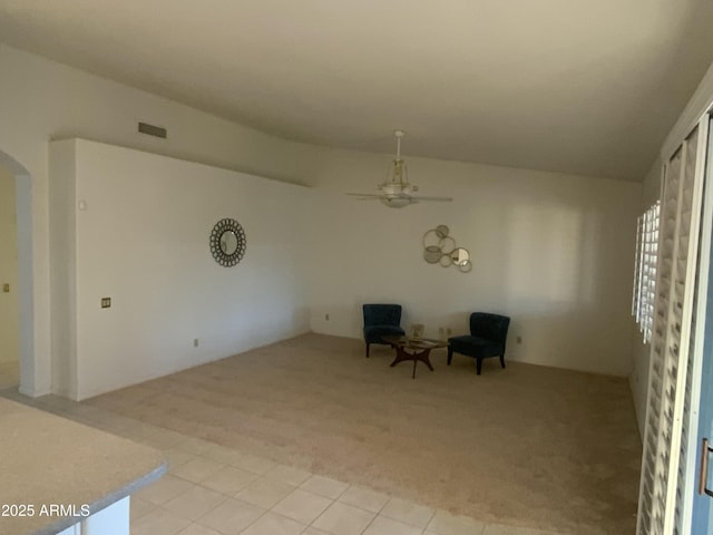 unfurnished room with ceiling fan and light colored carpet