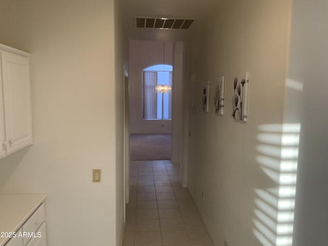 corridor with light tile patterned floors