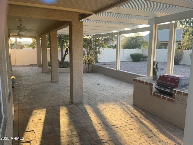 view of patio with a pergola, ceiling fan, and exterior kitchen