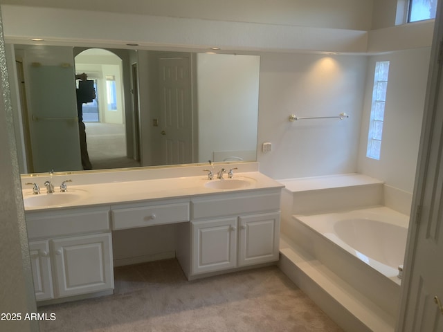 bathroom featuring vanity and a tub