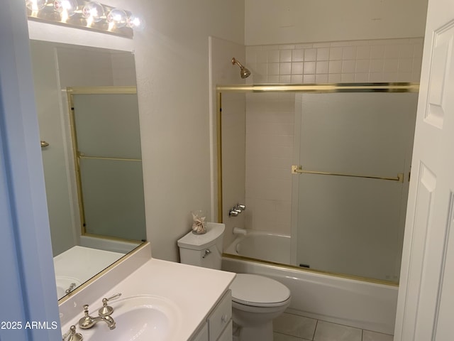 full bathroom with vanity, tile patterned floors, shower / bath combination with glass door, and toilet