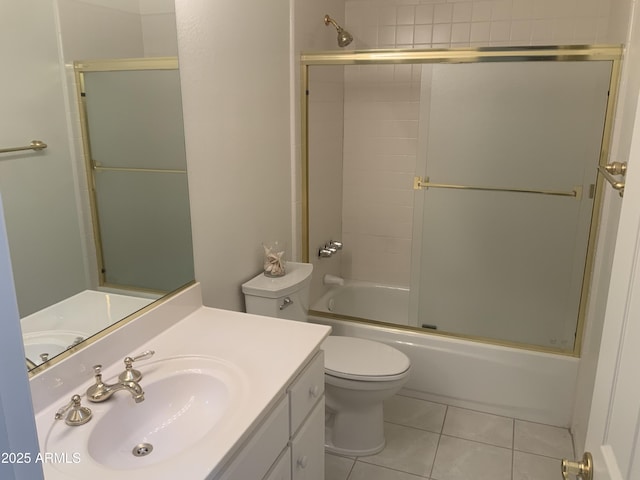 full bathroom with toilet, vanity, bath / shower combo with glass door, and tile patterned flooring