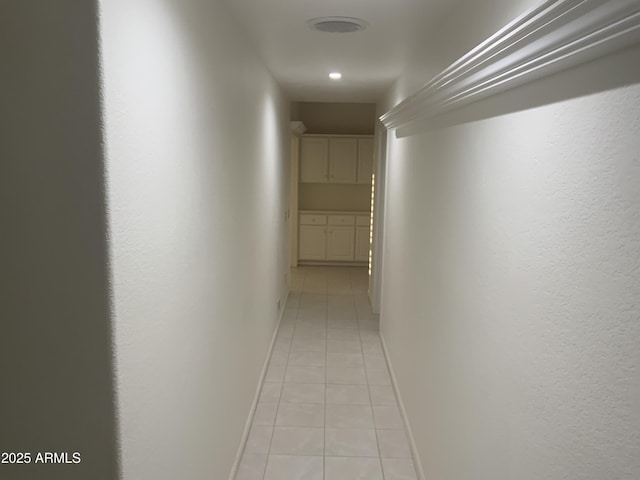 hall with light tile patterned floors