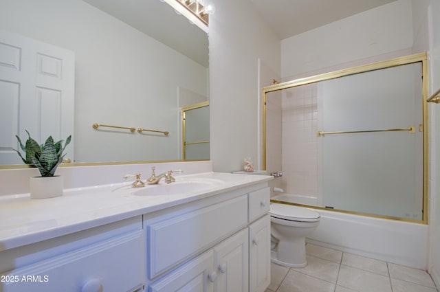 full bathroom featuring toilet, tile patterned floors, bath / shower combo with glass door, and vanity