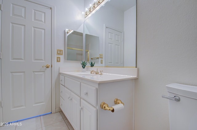 bathroom with tile patterned flooring, vanity, and toilet