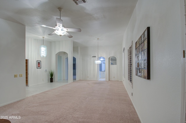 empty room featuring light carpet and ceiling fan