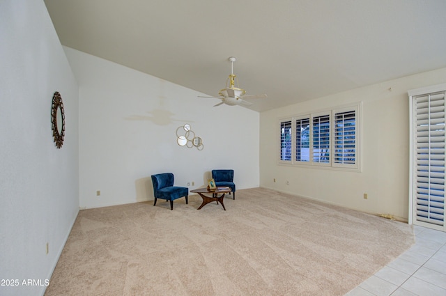living area with light carpet and ceiling fan