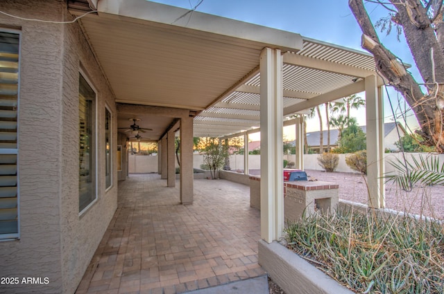 view of patio featuring ceiling fan and a pergola