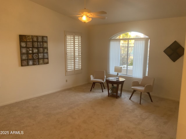 sitting room featuring vaulted ceiling, ceiling fan, and carpet floors