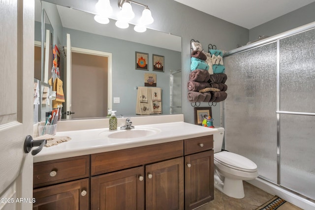 bathroom with vanity, a shower stall, toilet, and tile patterned floors