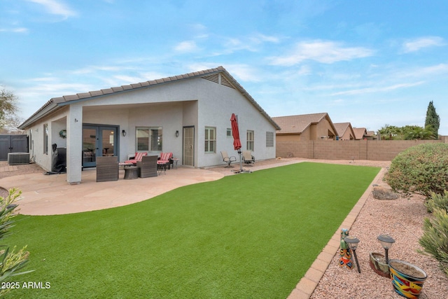 back of property with stucco siding, french doors, outdoor lounge area, a fenced backyard, and a patio