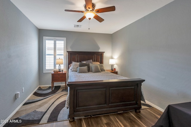 bedroom featuring visible vents, dark wood-type flooring, and baseboards