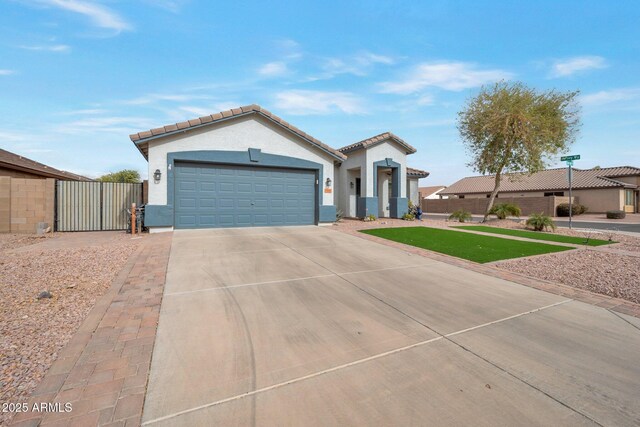 mediterranean / spanish house featuring fence, an attached garage, stucco siding, concrete driveway, and a tile roof