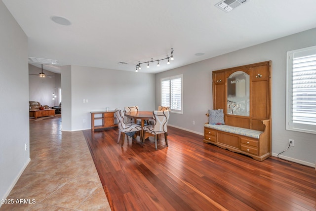 dining area with wood finished floors, visible vents, and baseboards