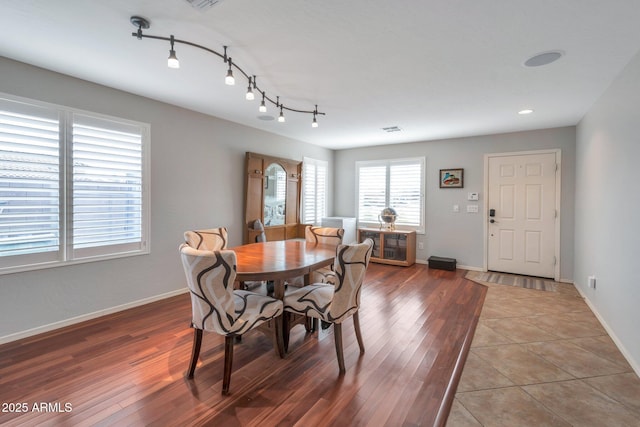 dining space with visible vents, baseboards, and light wood-style flooring