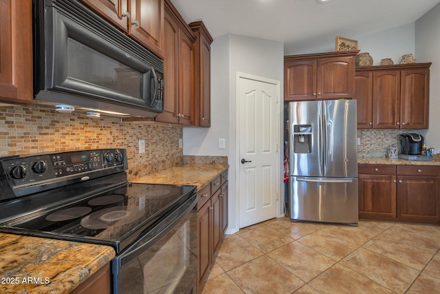 kitchen featuring light tile patterned floors, decorative backsplash, black appliances, and light stone counters