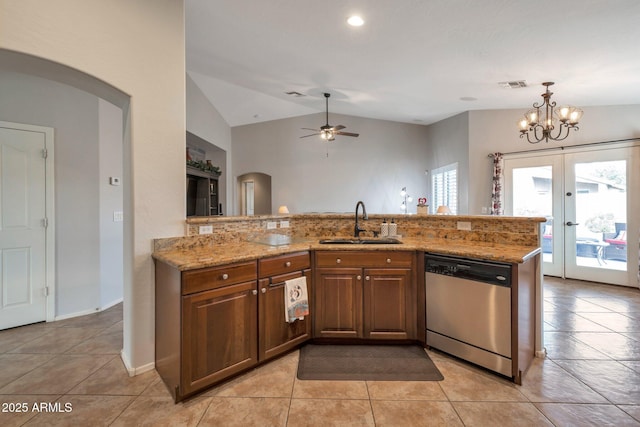 kitchen with stainless steel dishwasher, arched walkways, visible vents, and a sink