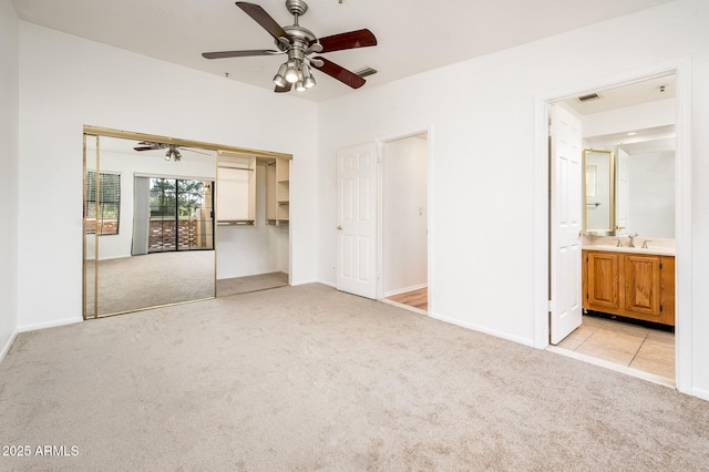 carpeted spare room with sink and ceiling fan