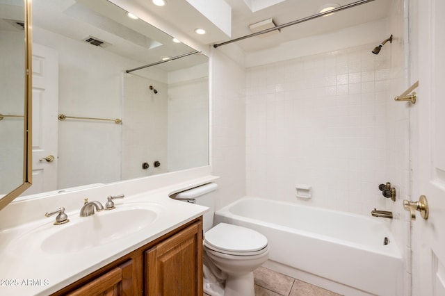 full bathroom with vanity, tiled shower / bath combo, tile patterned floors, and toilet