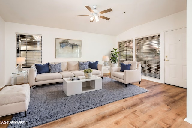 living room featuring a wealth of natural light, lofted ceiling, hardwood / wood-style floors, and ceiling fan