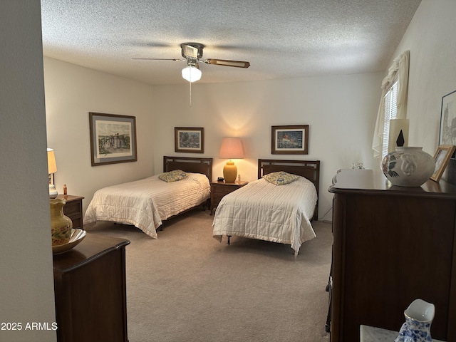 carpeted bedroom with a textured ceiling and ceiling fan