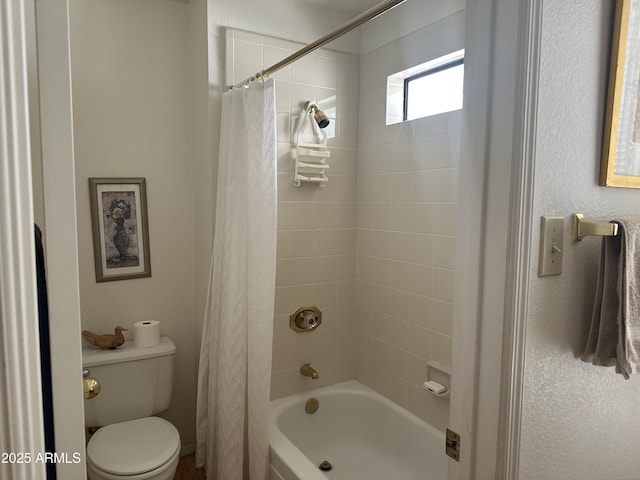 bathroom with shower / tub combo with curtain and toilet