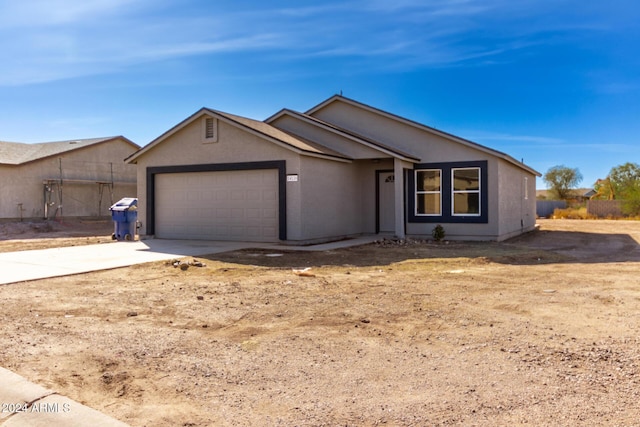 ranch-style home featuring a garage