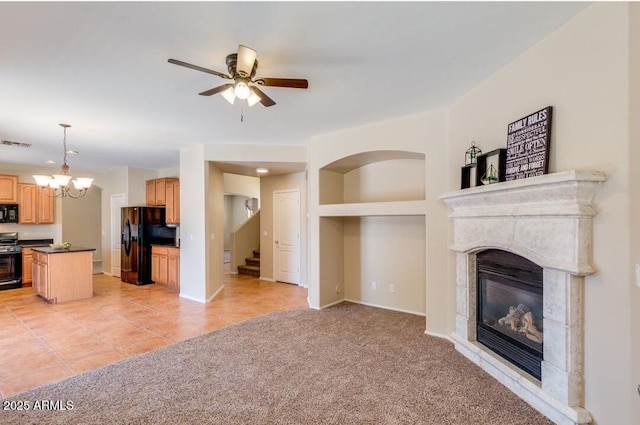 unfurnished living room featuring light colored carpet and ceiling fan with notable chandelier