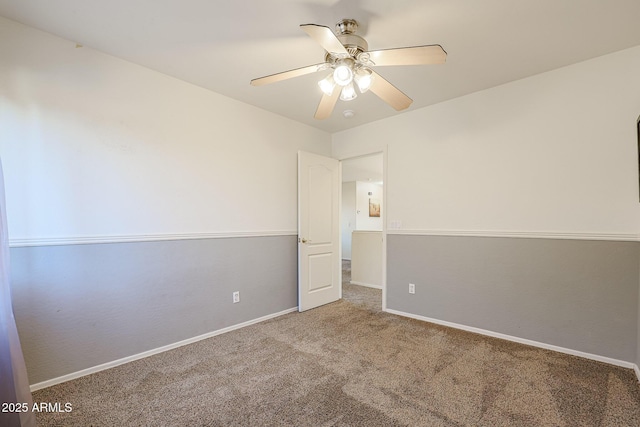 unfurnished room featuring ceiling fan and carpet