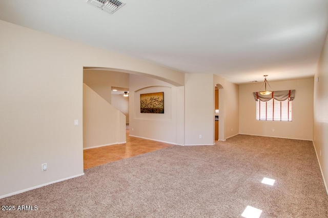 unfurnished room featuring light colored carpet