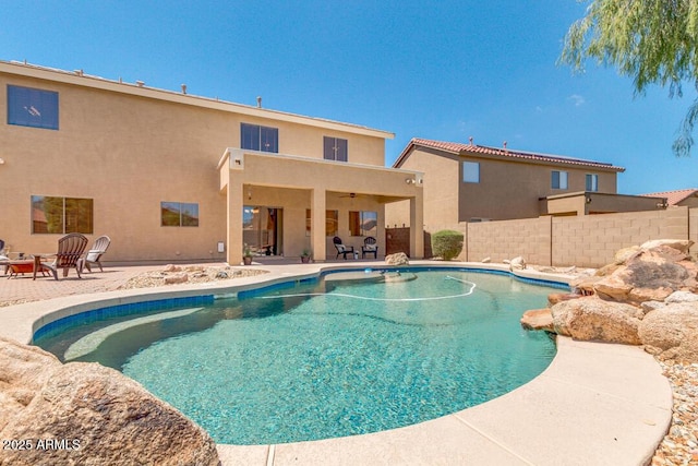 view of pool with a patio and ceiling fan