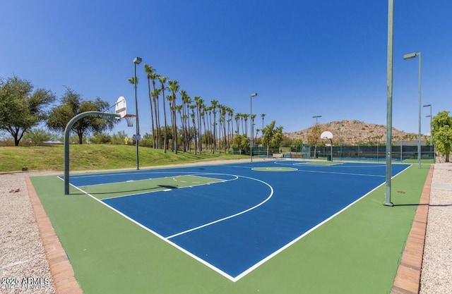 view of sport court featuring a yard