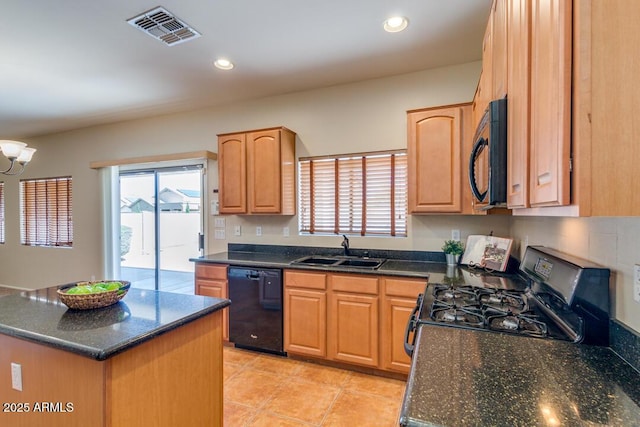 kitchen with sink, light tile patterned floors, black appliances, dark stone counters, and a chandelier