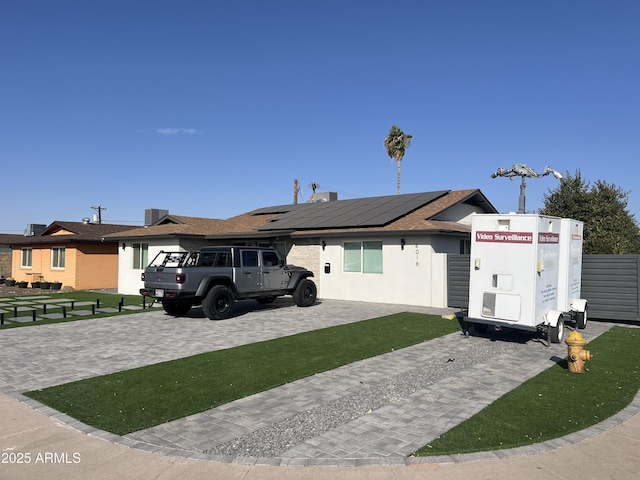 view of front of house featuring solar panels