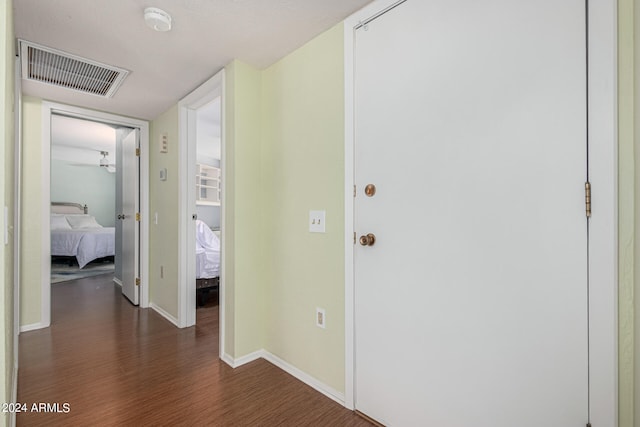 corridor featuring dark wood-type flooring