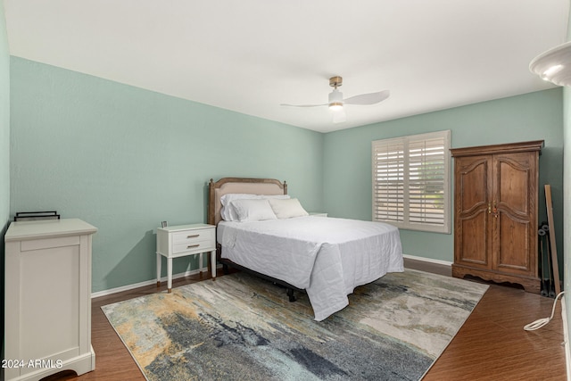 bedroom featuring ceiling fan and dark hardwood / wood-style floors