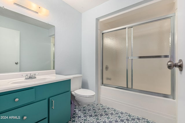 full bathroom featuring vanity, toilet, and enclosed tub / shower combo