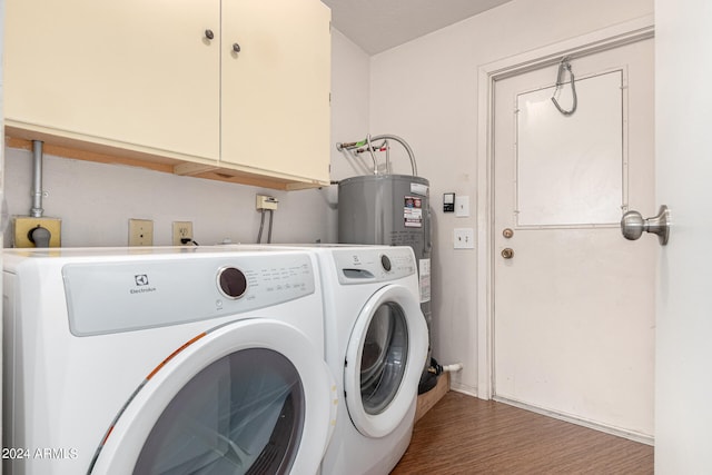 clothes washing area featuring dark hardwood / wood-style flooring, cabinets, and independent washer and dryer