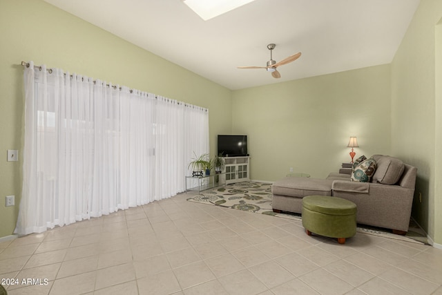 living room featuring light tile patterned floors and ceiling fan