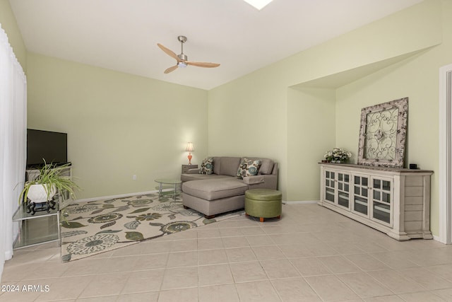 living room with ceiling fan, light tile patterned floors, and lofted ceiling